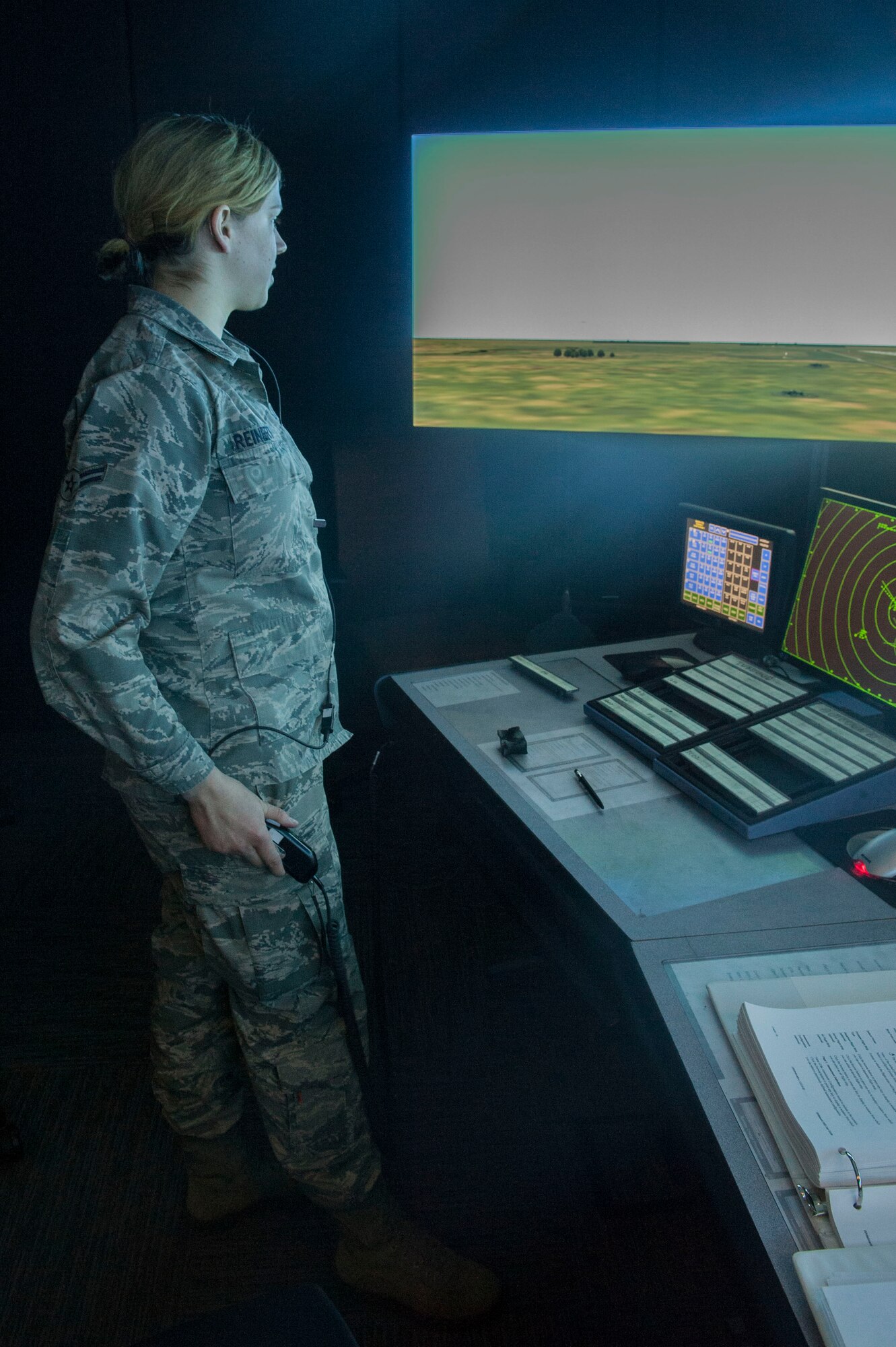 Airman 1st Class Latishia Reinert, a 5th Operations Support Squadron air traffic control journeyman, communicates with an aircraft during a simulated training exercise at Minot Air Force Base, N.D., April 6, 2016. In a real-world situation, controllers communicate with aircraft, weather, command post and air field management. (U.S. Air Force photo/Airman 1st Class Jessica Weissman)