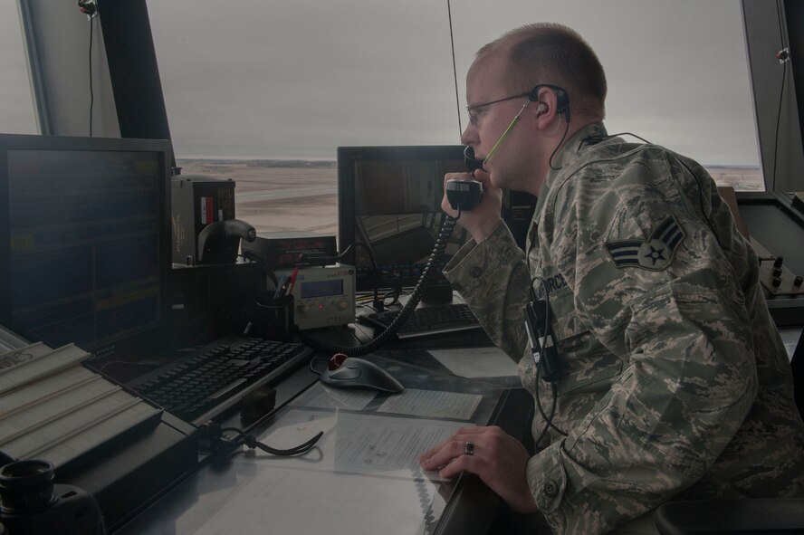 Senior Airman James Terry, a 5th Operations Support Squadron air traffic control journeyman, communicates with an aircraft at Minot Air Force Base, N.D., April 6, 2016. The primary responsibility of controllers is to support the nuclear mission through separation of aircraft and provide expeditious service to Team Minot. (U.S. Air Force photo/Airman 1st Class Jessica Weissman)