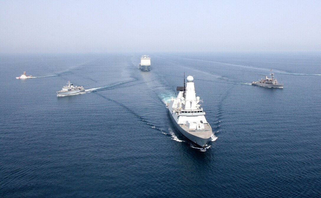 Royal Navy ship HMS Defender and Royal Fleet Auxiliary ship RFA Cardigan Bay anchor a formation of coalition mine countermeasures and maritime security vessels at sea, operating in support of the International Mine Countermeasures Exercise (IMCMEX). IMCMEX includes navies from more than 30 countries spanning six continents training together across the Middle East. (Royal Navy photo)