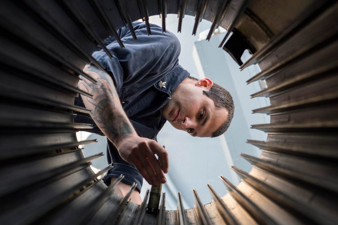 Navy Petty Officer 2nd Class Philip Torsell inspects the ammunition drum of a close-in weapon system aboard the guided-missile cruiser USS Anzio in the Arabian Gulf, April 8, 2016. The Anzio is supporting Operation Inherent Resolve and other security efforts in the U.S. 5th Fleet area of responsibility. Navy photo by Petty Officer 3rd Class Jacob Richardson