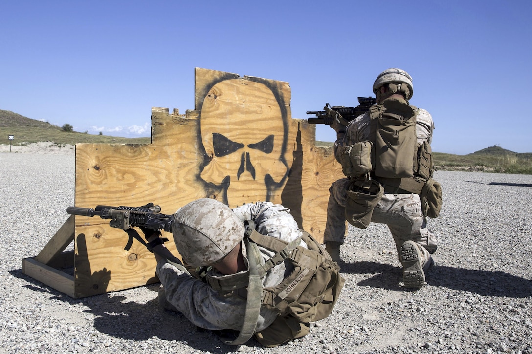 Marine Corps Lance Cpl. Corey Johnson, left, and Lance Cpl. Daniel Lopez fire their M4 carbines from behind a barricade during combat marksmanship training at Camp Pendleton, Calif., March 31, 2016. The event aims to hone combat marksmanship skills, including how to shoot, move and communicate with a buddy. Johnson and Lopez are mortarmen assigned to the 1st Marine Division's Weapons Company, 3rd Battalion, 1st Marine Regiment. Marine Corps photo by Cpl. Garrett White