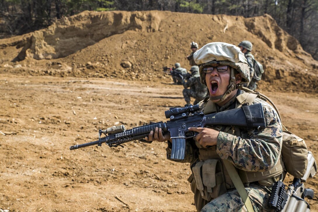 Marine Cpl. Edilberto Olguin shouts a command during a live-fire exercise as a part of the Korean Marine Exchange Program on Camp Rodriguez, South Korea, April 7, 2016. The bilateral event gives Marines the opportunity to train side-by-side and help improve the relationship between the two nations. Marine Corps photo by Cpl. Ryan C. Mains