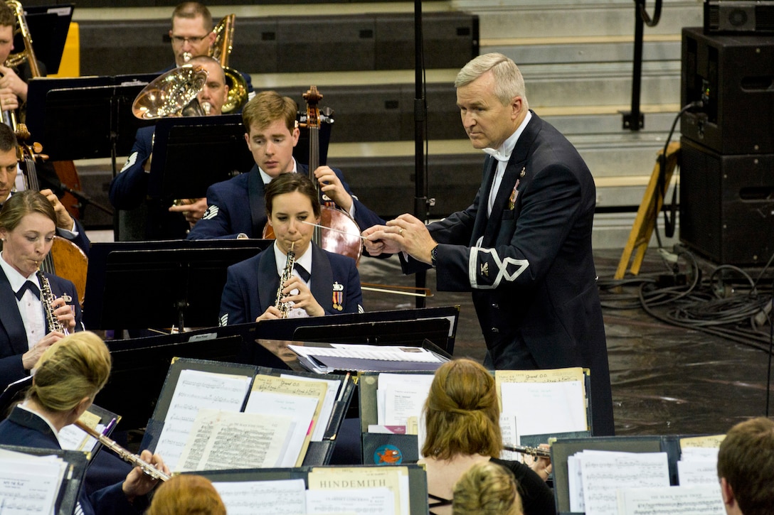 U.S. Air Force Col. Larry H. Lang, the commander and conductor of The United States Air Force Band, leads the Concert Band as they play for an audience at Little Rock Central High School, in Little Rock, Ark., Apr. 7, 2016. The United States Air Force Concert Band and Singing Sergeants are performing across five states during a 12-day spring tour. (U.S. Air Force photo by Master Sgt. Jeff Walston/Released)