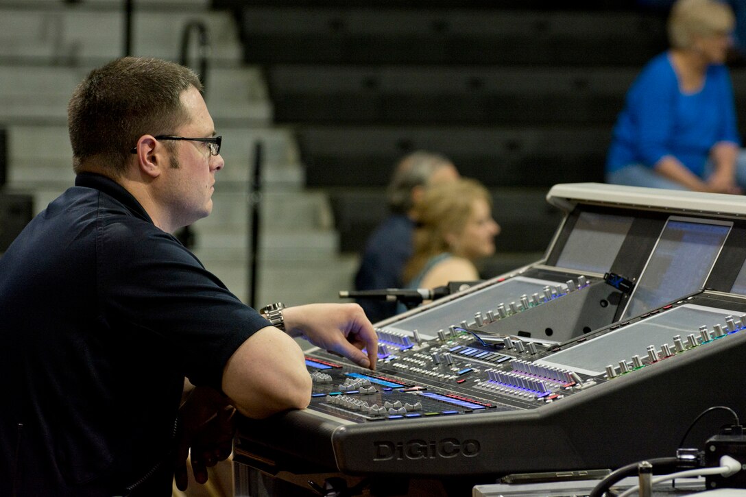 U.S. Air Force Senior Master Sgt. Adam Dempsey, sound engineer, United States Air Force Band, operates a soundboard during a performance of The United States Air Force Concert Band at Little Rock Central High School, in Little Rock, Ark., Apr. 7, 2016. The United States Air Force Concert Band and Singing Sergeants are the premier musical organization in the Air Force. (U.S. Air Force photo by Master Sgt. Jeff Walston/Released)