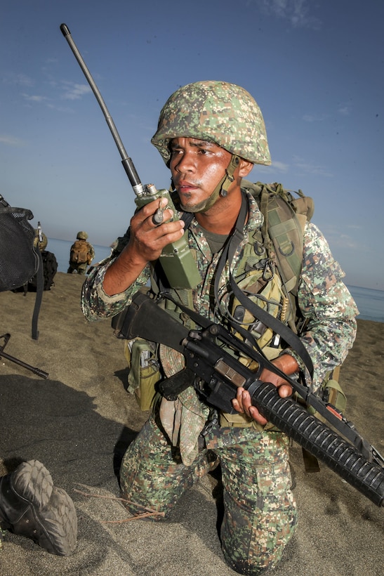 A Philippine marine member of the Joint Rapid Reaction Force (JRRF) communicates through radio to establish positive communication with other members after executing an amphibious landing to seize a scenario-based objective as part of Exercise Balikatan 2016, in Antique, Philippines, April 11, 2016. The JRRF, compiled of U.S. and Philippine forces, have worked together during the exercise to test their capabilities, maintain a high level of interoperability and to enhance combined combat readiness. Balikatan, which means "shoulder to shoulder" in Filipino, is an annual bilateral training exercise aimed at improving the ability of Philippine and U.S. military forces to work together during planning, contingency and humanitarian assistance and disaster relief operations.