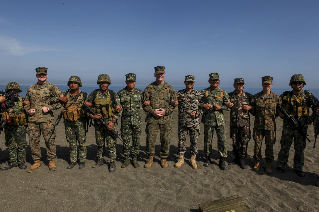 Philippine navy Vice ADM. Alexander S. Lopez, fifth from the right, commander of Western Command of the Armed Forces of the Philippines and U.S. Marine Corps Lt. Gen. John A. Toolan, sixth from the right, commander of U.S. Marine Corps Force, Pacific, pose for a photo shoulder-to-shoulder with U.S. and Philippine service members after observing the execution of an amphibious landing by the Joint Rapid Reaction Force (JRRF) to seize a scenario-based objective as part of Exercise Balikatan 2016, in Antique, Philippines, April 11, 2016. The JRRF, compiled of U.S. and Philippine forces, have worked together during the exercise to test their capabilities, maintain a high level of interoperability and to enhance combined combat readiness. Balikatan, which means "shoulder to shoulder" in Filipino, is an annual bilateral training exercise aimed at improving the ability of Philippine and U.S. military forces to work together during planning, contingency and humanitarian assistance and disaster relief operations.