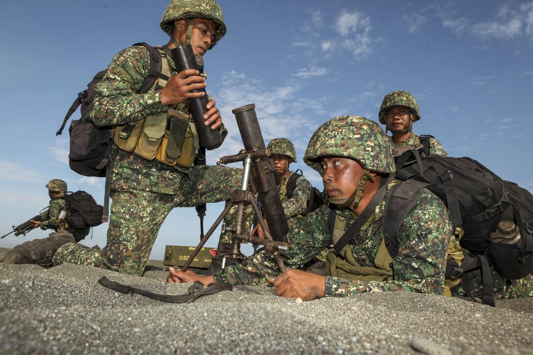 Philippine Marine members of the Joint Rapid Reaction Force (JRRF) prepare mortars tubes on the beach after executing an amphibious landing to seize a scenario-based objective as part of Exercise Balikatan 2016, in Antique, Philippines, April 11, 2016. The JRRF, compiled of U.S. and Philippine forces, have worked together during the exercise to test their capabilities, maintain a high level of interoperability and to enhance combined combat readiness. Balikatan, which means "shoulder to shoulder" in Filipino, is an annual bilateral training exercise aimed at improving the ability of Philippine and U.S. military forces to work together during planning, contingency and humanitarian assistance and disaster relief operations.