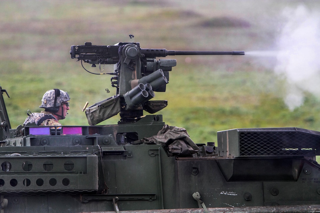 A soldier observes as a Stryker armored combat vehicle fires its M2 machine gun during a combined arms live-fire exercise at Joint Base Lewis-McChord, Wash., April 5, 2016. Army photo by Capt. Brian H. Harris