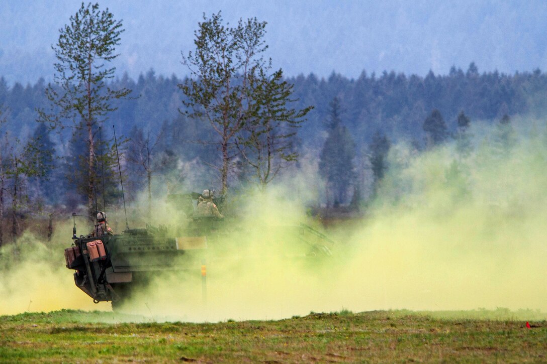 A Stryker armored combat vehicle moves through concealment smoke during a combined arms live-fire exercise at Joint Base Lewis-McChord, Wash., April 5, 2016. Army photo by Capt. Brian H. Harris