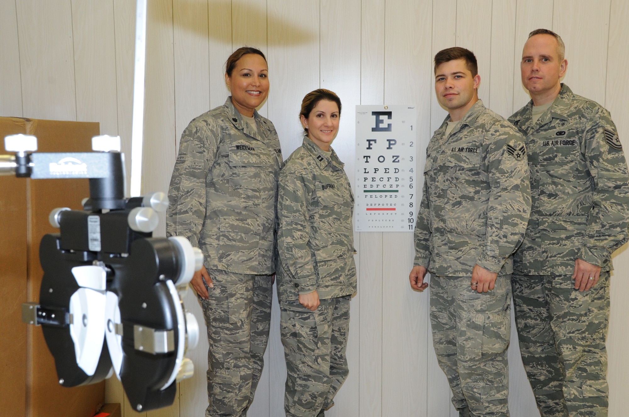 (Left to right) Air Force Reservists Lt. Col. Joni Scott-Weidemen, Tech. Sgt. John Murphy, Senior Airman Jesse Craig and Capt. Roxanne Buffano are all working in the optometry clinic during Operation Arctic Care, an Innovative Readiness Training project in Kodiak, Alaska. (U.S. Air Force photo by Bo Joyner)