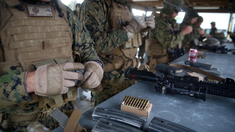 Scouts with 2nd Light Armored Reconnaissance Battalion load their ammunition in preparation for the live-fire portion of the battalion’s annual Isaak Competition at Camp Lejeune, N.C., April 7, 2016. The competition offered the scouts a plethora of different scenarios a scout must be able to accomplish, including casualty evacuation, call for fire, unknown distance marksmanship, and land navigation. (U.S. Marine Corps photo by Cpl. Joey Mendez)