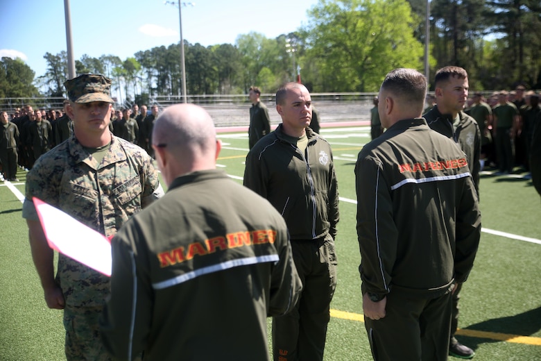 Sgt. Benjamin D. Patrick (center), a scout with 2nd Light Armored Reconnaissance Battalion, stands at attention as his Navy and Marine Corps Achievement Medal Citation is read aloud at Camp Lejeune, N.C., April 8, 2016. Patrick won the competition and was awarded the Navy and Marine Corps Achievement Medal, a four-day weekend, and the title “2nd LAR’s Best Scout.” (U.S. Marine Corps photo by Cpl. Joey Mendez)