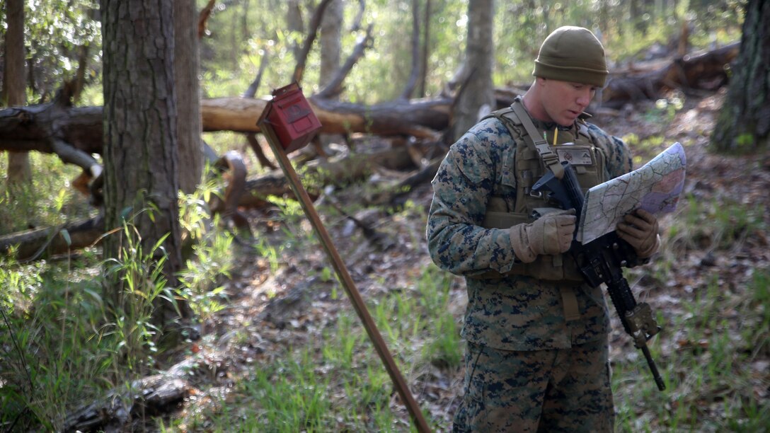 Lance Cpl. Silas F. Lewis, a scout with 2nd Light Armored Reconnaissance Battalion, reviews his map during the land navigation portion of the battalion’s annual Isaak Competition at Camp Lejeune, N.C., April 6, 2016. The competition offered the scouts a plethora of different scenarios a scout must be able to accomplish, including casualty evacuation, call for fire, unknown-distance marksmanship, and land navigation. (U.S. Marine Corps photo by Cpl. Joey Mendez)