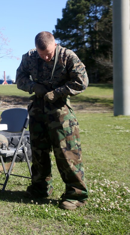 A scout with 2nd Light Armored Reconnaissance Battalion demonstrates his skills with gear intended to protect against chemical, biological, radiological, and nuclear attacks during the battalion’s annual Isaak Competition at Camp Lejeune, N.C., April 4, 2016. The competition offered the scouts a plethora of different scenarios a scout must be able to accomplish, including casualty evacuation, call for fire, unknown-distance marksmanship, and land navigation. (U.S. Marine Corps photo by Cpl. Joey Mendez)