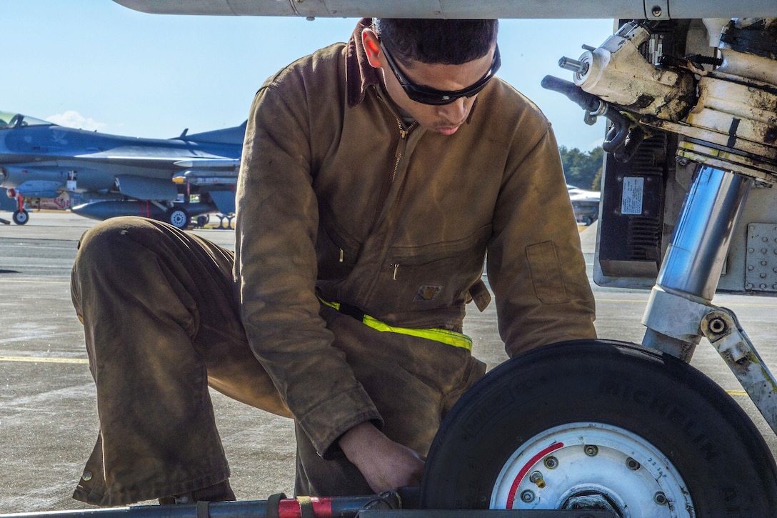 Air Force Senior Airman Kyle Lacy performs a post-flight inspection on an F-16 Fighting Falcon aircraft during a surge exercise at Misawa Air Base, Japan, April 5, 2016. Lacy is a crew chief assigned to the 35th Maintenance Squadron. Air Force photo by Airman 1st Class Jordyn Fetter