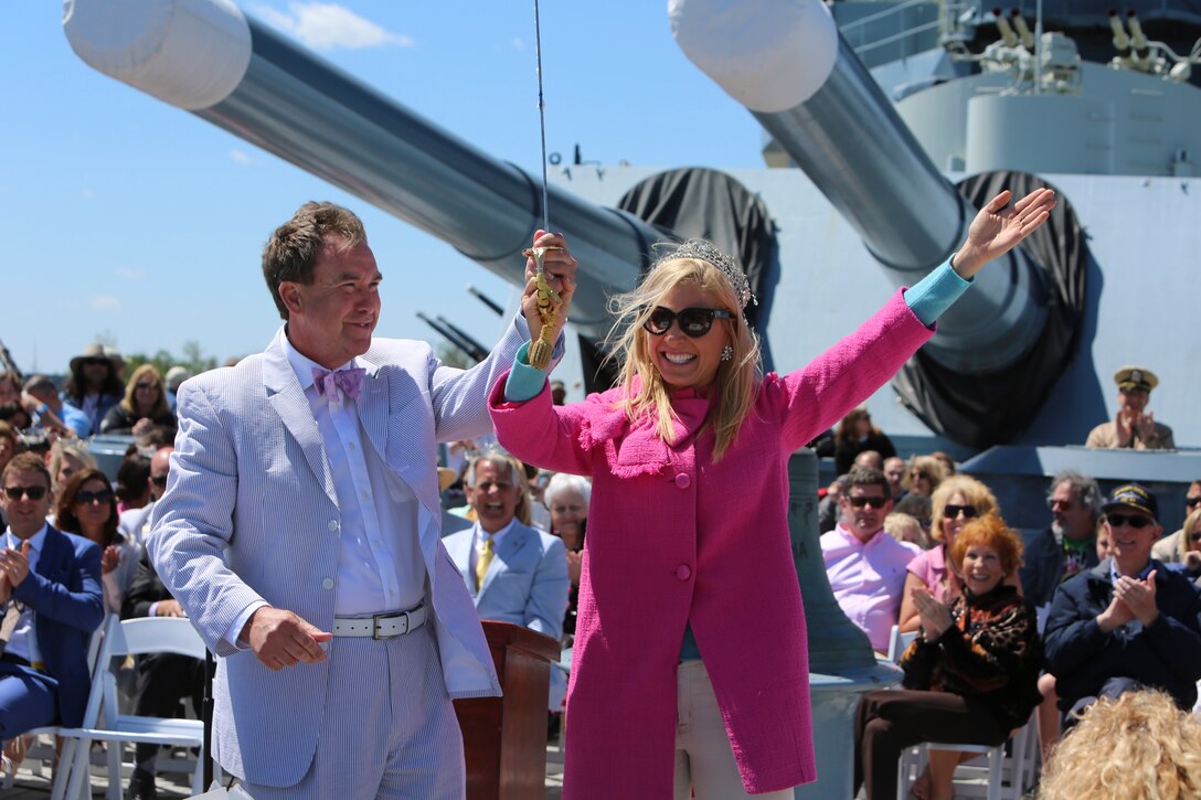 Anna Kooiman, Queen of the Azalea Festival, rejoices after cutting the ceremonial cake with the naval officer’s sword, kick-starting the celebration of the 75th anniversary of the USS North Carolina (BB-52) Battleship’s commissioning in Wilmington, N.C., April 9, 2016. Marines and sailors from 2nd Tank Battalion and other 2nd Marine Division units volunteered to work with museum staff and members of Living History to give real-life experiences to guests partaking in the festivity. (U.S. Marine Corps photo by LCpl. Miranda Faughn/Released)