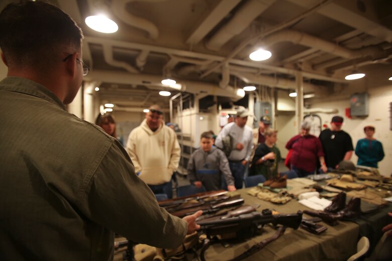 Marines with 8th Engineer Support Battalion teach guests about different artifacts, such as various weapons and uniforms, from the USS North Carolina (BB-52) Battleship’s time in service during celebration of the 75th anniversary of its commissioning in Wilmington, N.C., April 9, 2016. As part of the celebration Marines and sailors from 2nd Tank Battalion and other 2nd Marine Division units showcased how different parts of the ship were operated by role-playing throughout rooms of the USS North Carolina (BB-52). (U.S. Marine Corps photo by LCpl. Miranda Faughn/Released)
