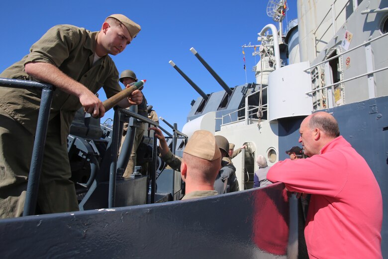 Marines with 2nd Tank Battalion work with members of the Living History crew to teach guests of the USS North Carolina (BB-52) Battleship about the past and present ways battleships are used, during the celebration of the 75th Anniversary of its commissioning in Wilmington, N.C., April 9, 2016. The Living History crew is made up of veterans and other volunteers that pass on the history of the battleship and give their knowledge and accounts for future generations at celebrations such as this. (U.S. Marine Corps photo by LCpl. Miranda Faughn/Released)