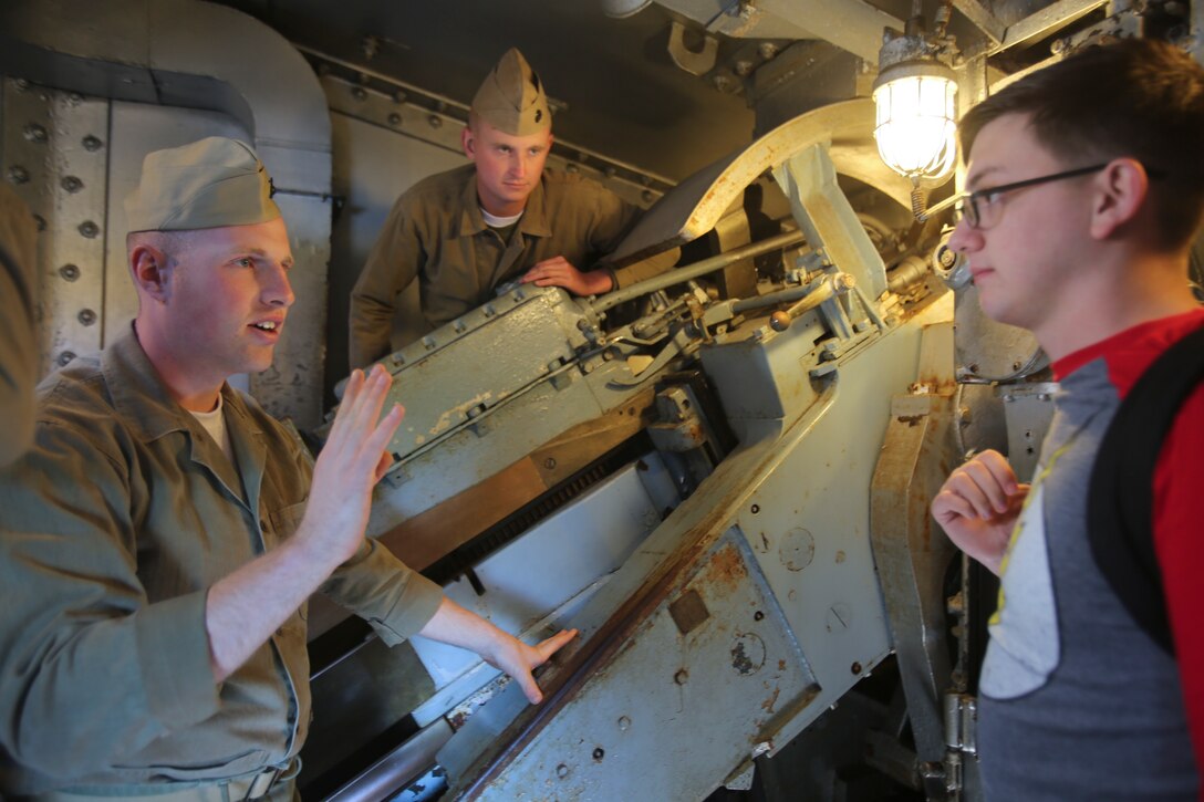 Marines with 2nd Tank Battalion explain the various duties of the 13-man job operating the 5-inch guns on the USS North Carolina (BB-52) Battleship at its memorial in Wilmington, N.C., April 9, 2016. Guests of the 75th anniversary celebration of the ship’s commissioning got the chance to see historical artifacts and role-playing of Marines and sailors with 2nd Tank Bn. and other 2nd Marine Division units as they showcased how different parts of the ship operated. (U.S. Marine Corps photo by LCpl. Miranda Faughn/Released)