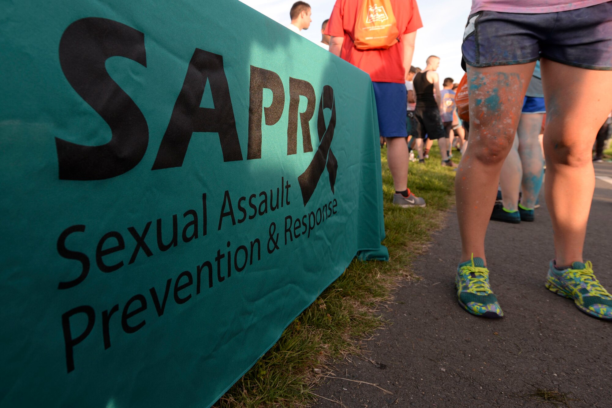 The Sexual Assault Prevention and Response table is on display during the Helping Agency 5K on Barksdale Air Force Base, La., April 8, 2016. The 5K was held to support awareness campaigns to include Sexual Assault Awareness Month.  (U.S. Air Force photo/Senior Airman Jannelle Dickey)