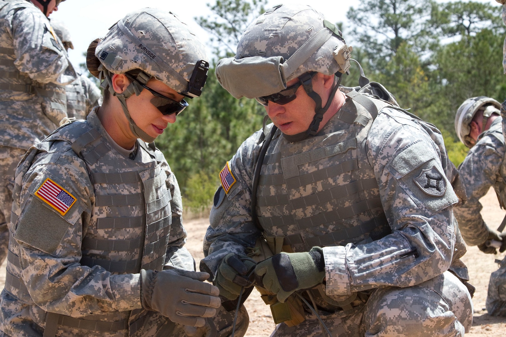Florida National Guard members Spc. Maryi Burnside, left, and Sgt. Vic Harper, both with the 779th Engineer Battalion, prepare a piece of detonation cord with that will be attached to a block of Composition C4, April 10, 2016, at McCrady Training Center. Two blocks of C4 were attached to a 40-pound crater charge and lowered into a previously created hole, which will be set off to create a crater obstacle. Soldiers learned numerous new techniques during a two-week Combat Engineer Course, reclassifying as 12B at McCrady Training Center. 
