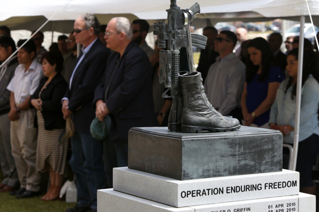 Veterans, family members and friends stand in a moment of silence for all the fallen Marines of 1st Battalion, 2nd Marine Regiment during a memorial ceremony held at the battalion headquarters building on Camp Lejeune, N.C., April 9, 2016. The ceremony focused on the 2010 Afghanistan deployment but was open to all veterans of 1/2 in order to build a network of friends for the veterans to rely on. (U.S. Marine Corps photo by Cpl. Melodie Snarr/Released)