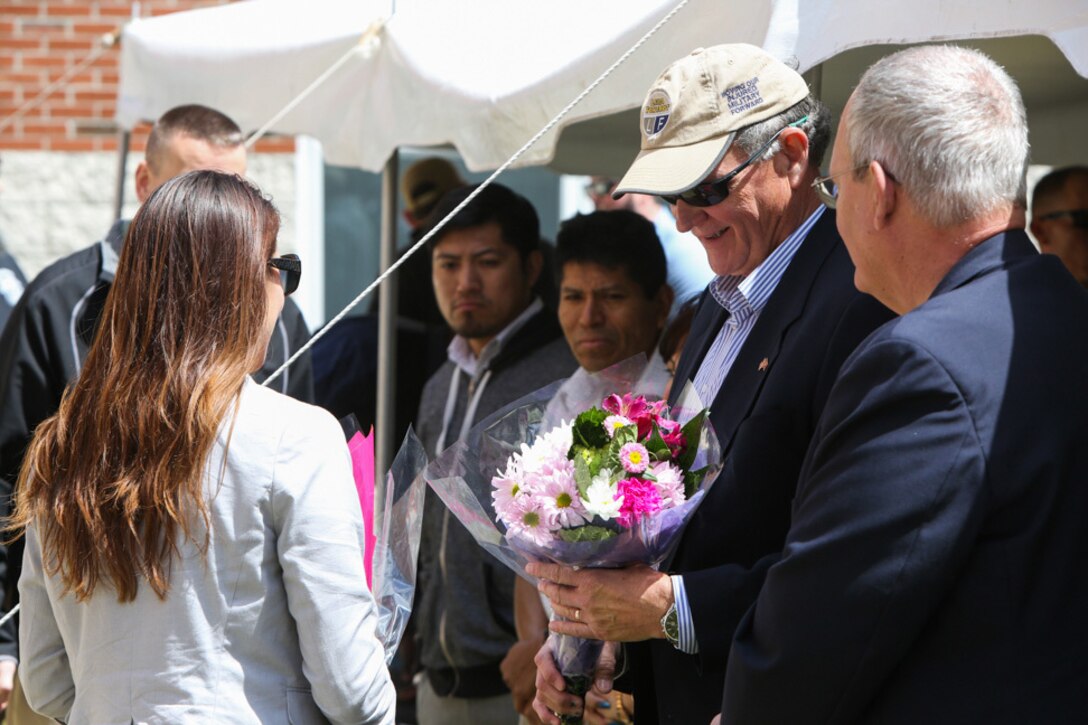Gold star father Tom Rivers Sr. receives flowers for his fallen son during a memorial ceremony held at the 1st Battalion, 2nd Marine Regiment headquarters building at Camp Lejeune, North Carolina, April 9, 2016. Rivers’ son was among one of the ten Marines who died during the 2010 Afghanistan deployment, which was the focus of the memorial. (U.S. Marine Corps photo by Cpl. Melodie Snarr/Released)