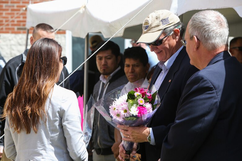 Gold star father Tom Rivers Sr. receives flowers for his fallen son during a memorial ceremony held at the 1st Battalion, 2nd Marine Regiment headquarters building at Camp Lejeune, North Carolina, April 9, 2016. Rivers’ son was among one of the ten Marines who died during the 2010 Afghanistan deployment, which was the focus of the memorial. (U.S. Marine Corps photo by Cpl. Melodie Snarr/Released)