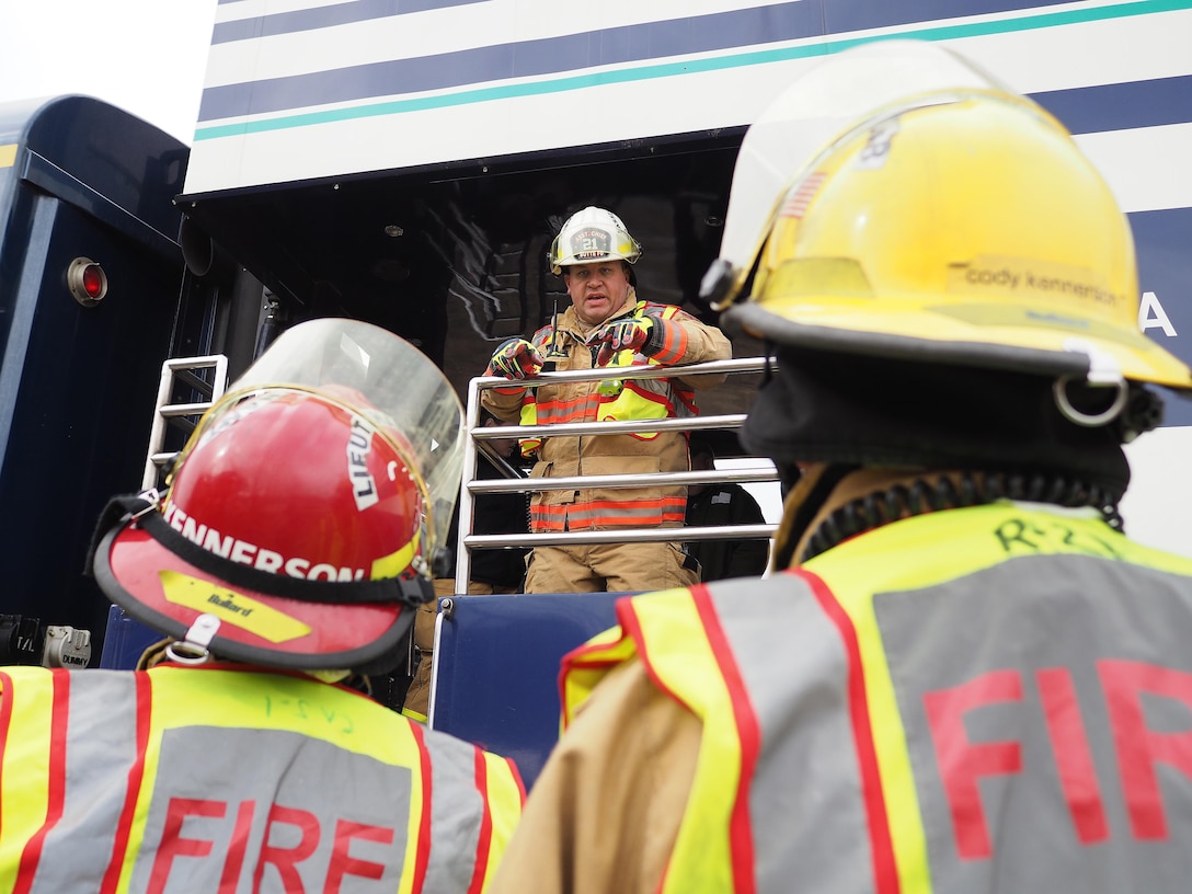 Jason Edmison, center, directs firefighters at the Alaska State Fairgrounds during exercise Alaska Shield 2016, Palmer, Alaska, April 2, 2016. Area first responders and soldiers participated in a mass-casualty response exercise during a simulated crash of an Alaska railroad passenger train into a school bus. Edmison is assistant Butte Fire Chief. Alaska Army National Guard photo by Sgt. David Bedard