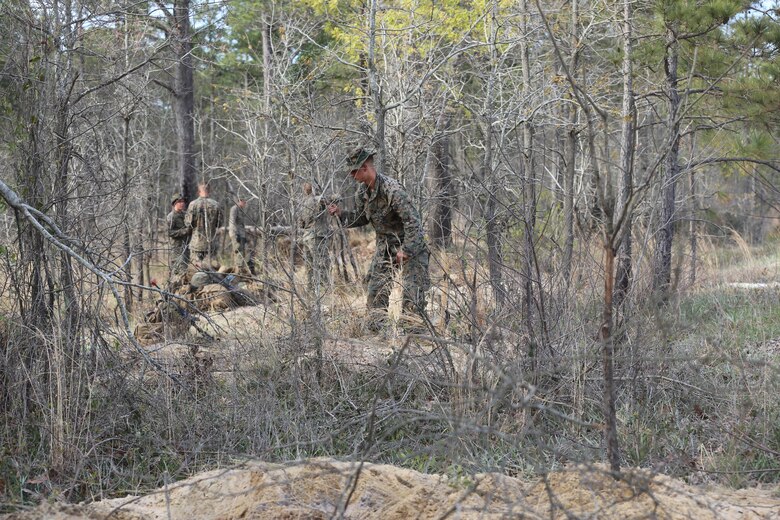 Marines with 2nd Combat Engineer Battalion, 2nd Marine Division camouflage their fighting positions during their annual Marine Corps Combat Readiness Evaluation on Camp Lejeune, N.C., April 4-8, 2016.The Marines constructed skirmishers holes and various types of bunkers, as well as obstacles such as concertina wire and tank ditches to hinder the opposing forces they faced. (U.S. Marine Corps photo by Cpl. Shannon Kroening/ Released)
