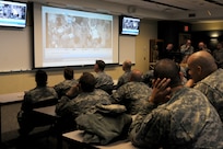 Soldiers from the 399th Combat Support Hospital, 804th Medical Brigade, 3d Medical Command (Deployment Support) watch video footage of their performance during an exercise held April 2, 2016 at the Mayo Clinic Multidisciplinary Simulation Center in Rochester, Minnesota. The unit's every move was recorded at the facility, which allowed them review and improve their performance throughout the course of the exercise. During the exercise, the unit, which is based out of Fort Devens, Massachusetts, practiced the Team Strategies and Tools for Enhanced Performance and Patient Safety, or TeamSTEPPS, model of patient care. TeamSTEPPS is a framework implemented by the Department of Defense to optimize performance of military medical teams and reduce communication errors that can result in improper patient care.