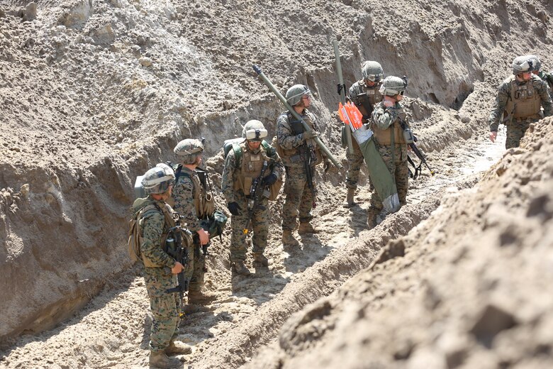 Marines with 2nd Combat Engineer Battalion, 2nd Marine Division prepare to scale a sand ridge and overcome obstacles, clearing a path on the other side of the ridge during their annual Marine Corps Combat Readiness Evaluation on Camp Lejeune, N.C., April 4-8, 2016.The Marines operated in two groups, each group preparing to engage two different sides of the defensive obstacles. (U.S. Marine Corps photo by Cpl. Shannon Kroening/ Released)