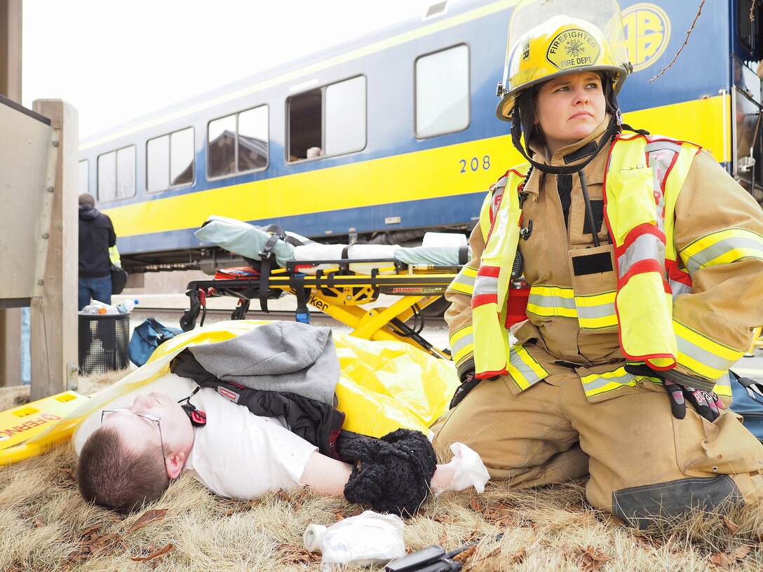 Firefighter Amy Bohmbach assesses a simulated casualty played by Alaska State Defense Force Staff Sgt. Steven Flippen at the Alaska State Fairgrounds during exercise Alaska Shield 2016, Palmer, Alaska, April 2, 2016. Alaska Army National Guard photo by Sgt. David Bedard
