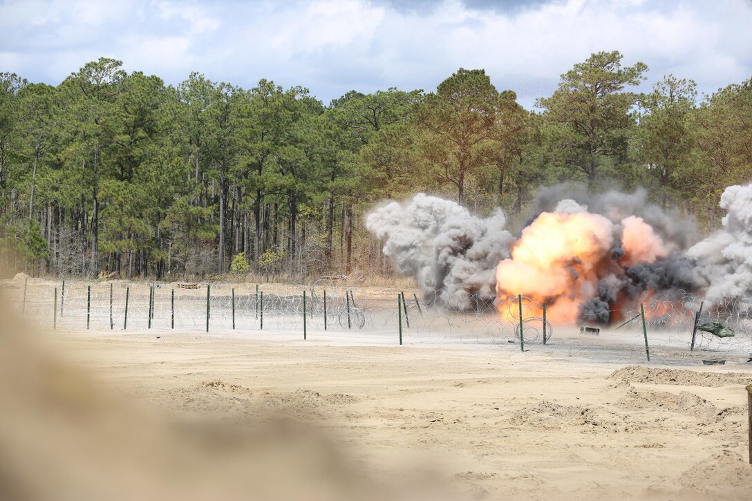 2nd Combat Engineer Battalion, 2nd Marine Division detonate their explosives to clear the way of concertina wire and various defensive obstacles for the remainder of their forces to pass through during their annual Marine Corps Combat Readiness Evaluation on Camp Lejeune, N.C., April 4-8, 2016.The Marines operated in two groups, each group preparing to engage two different sides of the defensive obstacles.(U.S. Marine Corps photo by Cpl. Shannon Kroening/ Released)