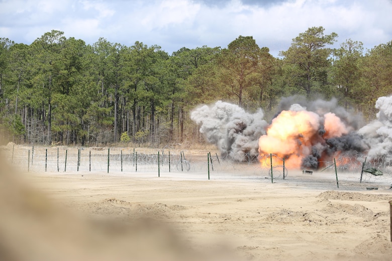 2nd Combat Engineer Battalion, 2nd Marine Division detonate their explosives to clear the way of concertina wire and various defensive obstacles for the remainder of their forces to pass through during their annual Marine Corps Combat Readiness Evaluation on Camp Lejeune, N.C., April 4-8, 2016.The Marines operated in two groups, each group preparing to engage two different sides of the defensive obstacles.(U.S. Marine Corps photo by Cpl. Shannon Kroening/ Released)