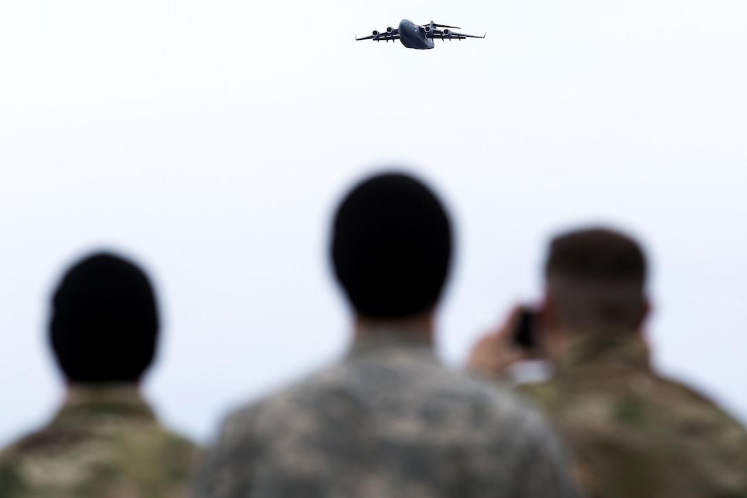 Paratroopers watch an Air Force C-17 Globemaster III aircraft approach during a practice forced-entry parachute assault onto Malemute drop zone at Joint Base Elmendorf-Richardson, Alaska, April 5, 2016. The paratroopers are assigned to the 25th Infantry Division’s 4th Brigade Combat Team (Airborne). Air Force photo by Justin Connaher