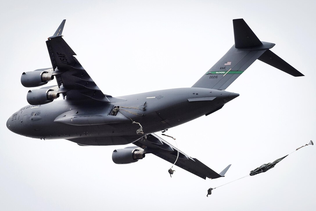 Paratroopers exit an Air Force C-17 Globemaster III aircraft during a practice forced-entry parachute assault onto Malemute drop zone at Joint Base Elmendorf-Richardson, Alaska, April 5, 2016. Air Force photo by Justin Connaher