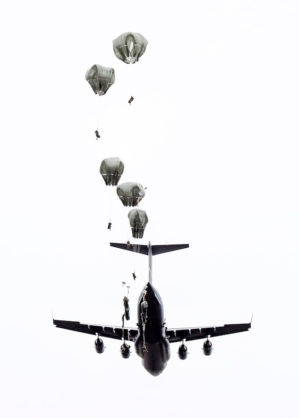 Paratroopers jump from an Air Force C-17 Globemaster III aircraft during a practice forced-entry parachute assault onto Malemute drop zone at Joint Base Elmendorf-Richardson, Alaska, April 5, 2016. Air Force photo by Justin Connaher