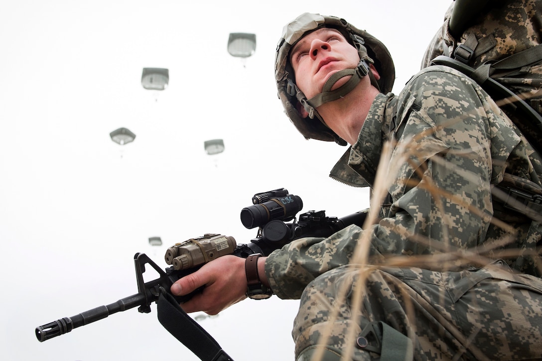 Army Spc. Nathan Lycan provides security during a practice forced-entry parachute assault onto Malemute drop zone at Joint Base Elmendorf-Richardson, Alaska, April 5, 2016. Air Force photo by Justin Connaher