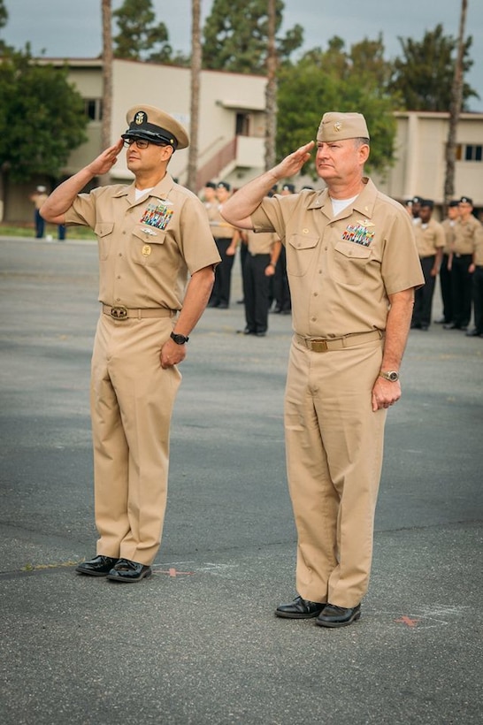 U.S. Navy Master Chief Edgar M. Santiago, left, and Capt. Theodore Briski, right, salute during the U.S. Navy Chief Petty Officer 123rd birthday cake-cutting ceremony aboard Camp Pendleton, Calif. April 1, 2016. Briski is the commanding officer and Santiago is the command master chief of 1st Medical Battalion, 1st Marine Logistics Group. The battalion provides health service support to the operating units of I Marine Expeditionary Force to reach full mission accomplishment. (U.S. Marine Corps photo by Sgt. Laura Gauna/released)