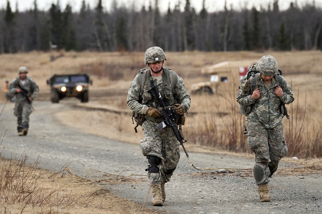 Paratroopers make their way to a rally point after a practice forced-entry parachute assault onto Malemute drop zone at Joint Base Elmendorf-Richardson, Alaska, April 5, 2016. Air Force photo by Justin Connaher