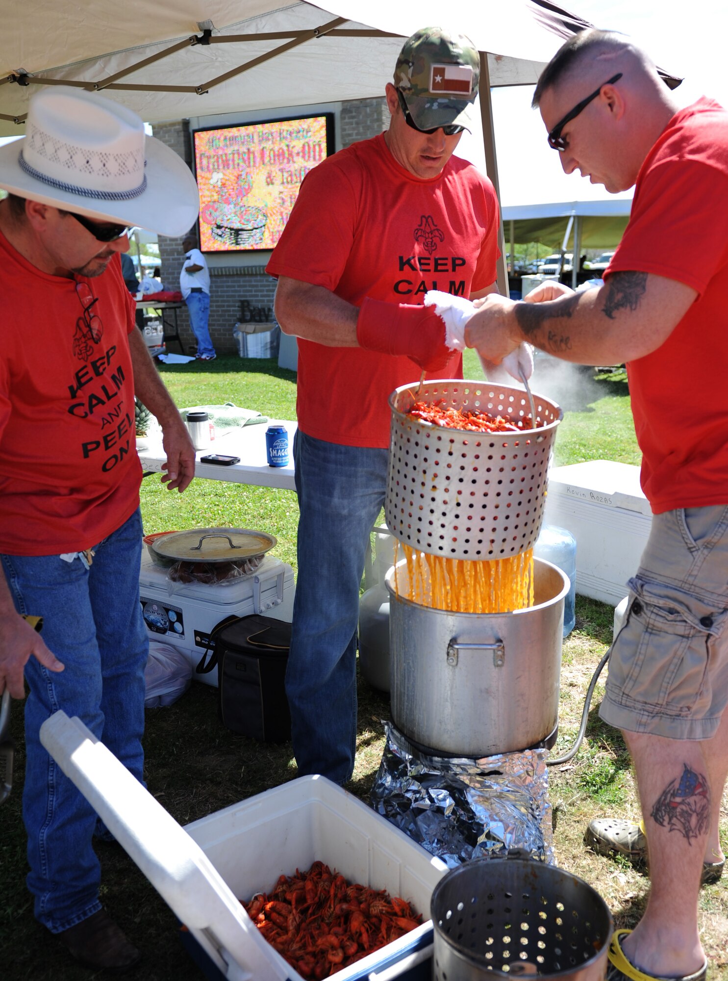 The “Claws Down Tails Up” team members, Kevin Rozas, father of Staff Sgt. Kevin Rozas, 81st Security Forces Squadron patrolman; Master Sgt. Aaron Gaddis, 81st SFS antiterrorism officer; and Staff Sgt. Jared Miller, 81st SFS combat arms NCO in charge, lift freshly boiled crawfish from a pot during the 4th Annual Bay Breeze Crawfish Cook-Off at the Bay Breeze Event Center April 8, 2016, Keesler Air Force Base, Miss. The “Bug Smugglers” won the cook-off and decided to gift the trophy and the prize to the second place team, “Kajun Perfection”. “Kajun Perfection” will receive a free entry into the 24th Annual Mississippi Coast Coliseum Crawfish Festival Cook-Off. (U.S. Air Force photo by Kemberly Groue)