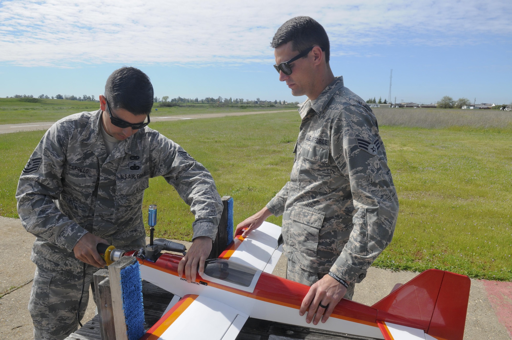Tech. Sgt. Michael Carrillo (left) and Senior Airman Justin Joyner, 349th Air Mobility Wing Detachment 1 KC-135 crew chiefs, prep a radio-controlled plane for flight at Beale Air Force Base, California March 25, 2016. Carrillo is a member of the Beale Blackbirds Radio Control Club. (U.S. Air Force photo by Senior Airman Michael J. Hunsaker)