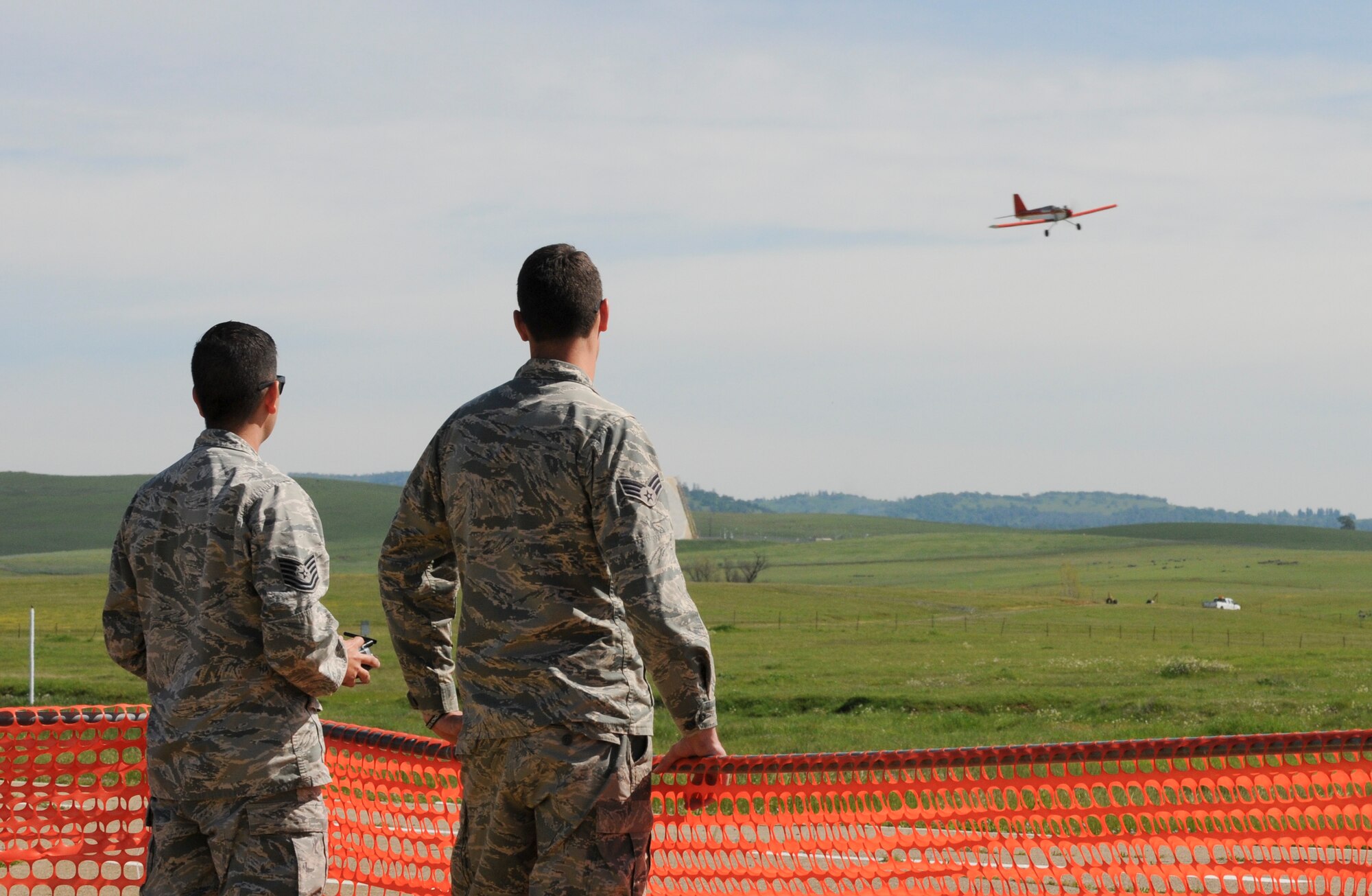 Tech. Sgt. Michael Carrillo (left), 349th Air Mobility Wing Detachment 1 KC-135 crew chief, flies a radio-controlled aircraft as an Airman observes at Beale Air Force Base, California March 25, 2016. Carrillo has been a member of the Beale Blackbirds Radio Control Club for more than six months. (U.S. Air Force photo by Senior Airman Michael J. Hunsaker)