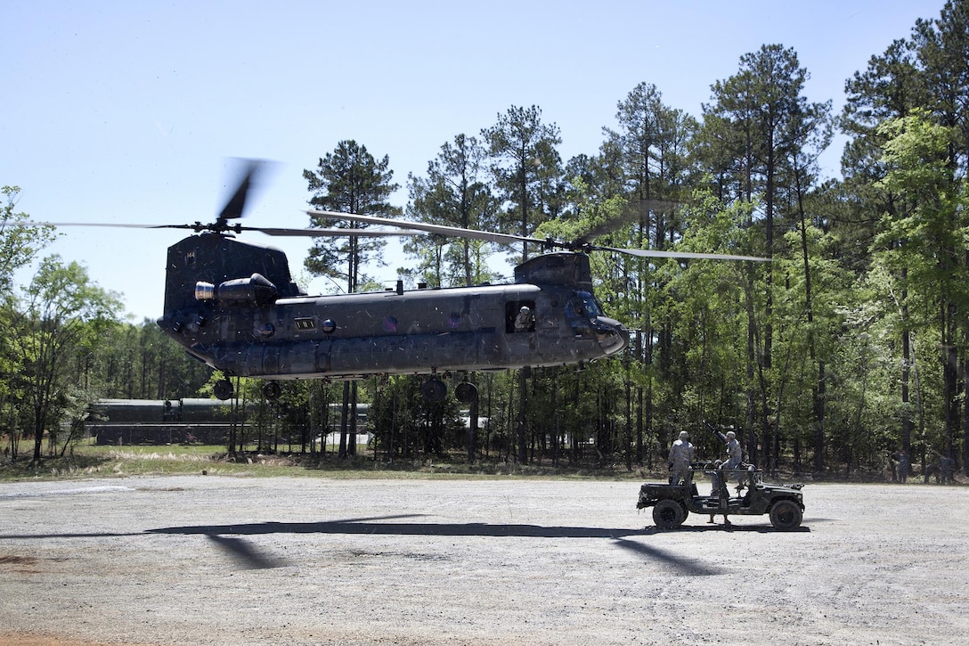 Soldiers prepare to hookup a Humvee to a CH-47D Chinook helicopter during slingload training at Clarks Hill Training Site at Plum Branch, South Carolina, April 2, 2016. South Carolina Army National Guard photo by Capt. Brian Hare