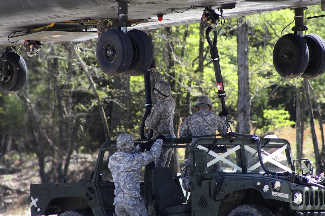 Soldiers hookup a Humvee to a CH-47D Chinook helicopter during slingload training at Clarks Hill Training Site at Plum Branch, South Carolina, April 2, 2016. South Carolina Army National Guard photo by Capt. Brian Hare