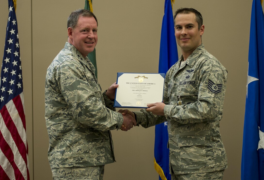 Tech. Sgt. Dean Criswell, right, the 22nd Special Tactics Squadron NCO in charge of rescue operations, receives the Airman’s medal during a ceremony April 8, 2016, at Fairchild Air Force Base, Wash. Criswell and Maj. Matthew Arnold, the 336th Training Group chief of standards and evaluations, put their lives in danger to save the lives of three Airmen on a HH-60G Pave Hawk that crashed during training. (U.S. Air Force photo/Airman 1st Class Sean Campbell)