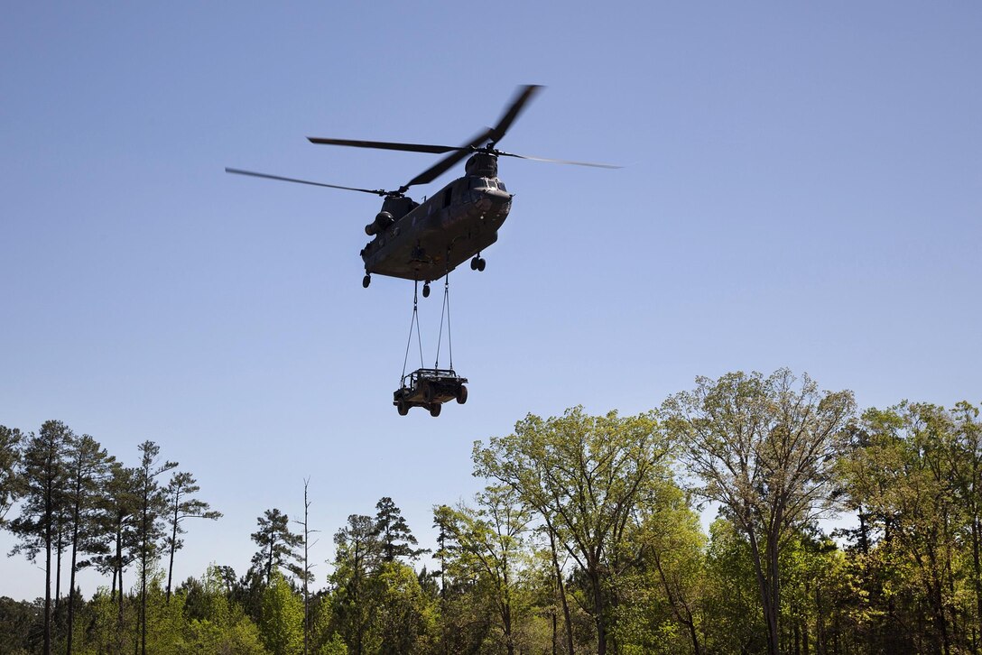 A CH-47D Chinook helicopter lifts off during slingload training at Clarks Hill Training Site at Plum Branch, South Carolina, April 2, 2016. South Carolina Army National Guard photo by Capt. Brian Hare