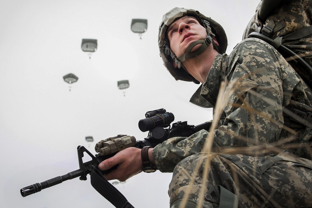 Army Spc. Nathan Lycan provides security during a practice forced-entry parachute assault onto Malemute drop zone at Joint Base Elmendorf-Richardson, Alaska, April 5, 2016. Lynn is assigned to the 25th Infantry Division’s Headquarters Company, 3rd Battalion (Airborne), 509th Infantry Regiment, 4th Brigade Combat Team (Airborne). Air Force photo by Justin Connaher