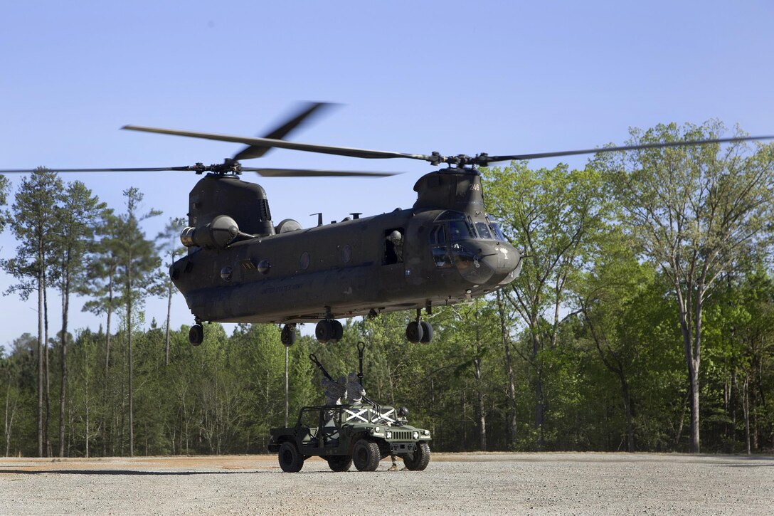 Soldiers hookup a Humvee to a CH-47D Chinook helicopter during slingload training at Clarks Hill Training Site at Plum Branch, South Carolina, April 2, 2016. South Carolina Army National Guard photo by Capt. Brian Hare